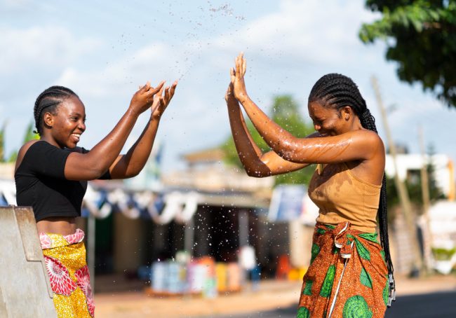 African young ladies fetching water and playing - 01252022